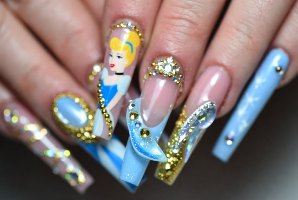 Beauty and the Beast nail ideas 2026 featuring dramatic coffin-shaped acrylic nails with intricate 3D enchanted rose designs in deep red and gold on a dark background with green leaves and stems