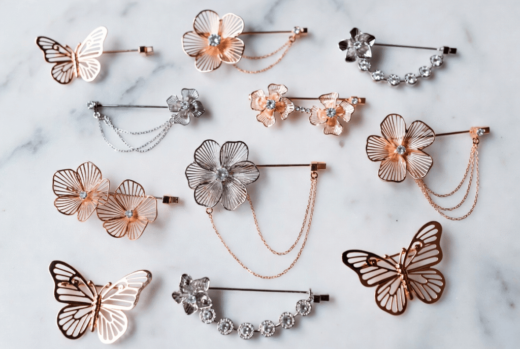 A stunning collection of brooch aesthetic jewelry featuring vintage gold cameos, modern crystal statement pieces, and pearl clusters artfully arranged on soft velvet. The display captures the timeless elegance and diversity of brooch design for ladies, from heirloom treasures to luxury designer brooches.